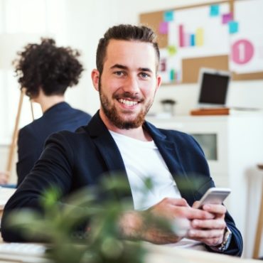 demo-attachment-87-a-portrait-of-young-businessman-with-smartphone-A2GKEC4